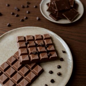Close-up of various chocolate types on rustic plates, showcasing texture and indulgence.