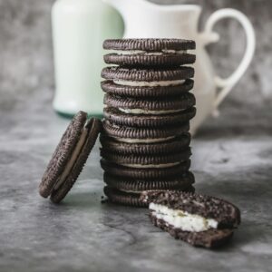 Photo by Tijana Drndarski Delicious stack of chocolate cookies and milk bottle on a marble surface, perfect for an indulgent breakfast.